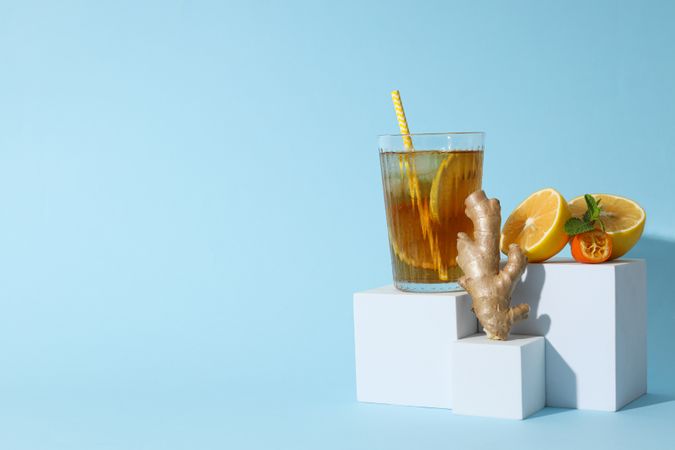 A glass of cold tea on a blue background