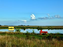 A bright-red freight wagon and bright-yellow cabin,  near the town of Dike, Iowa