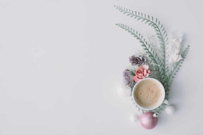 Coffee with flowers, leaves and pink Christmas decoration