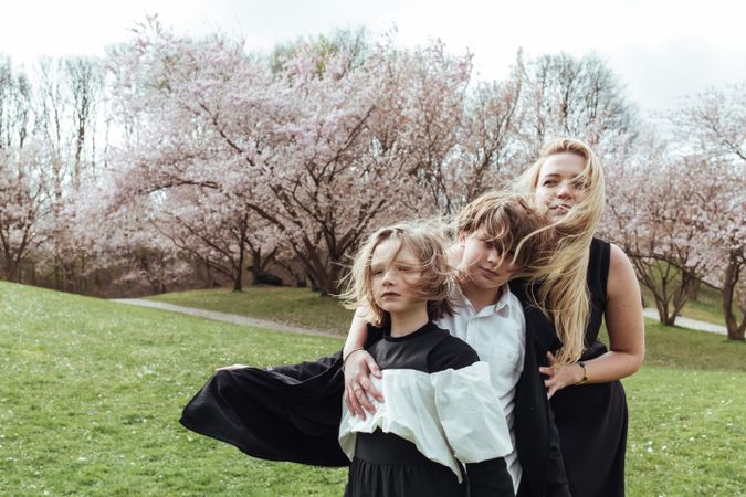 Mother and children near blooming trees