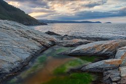 Idyllic landscape of rocked seaside and mountains
