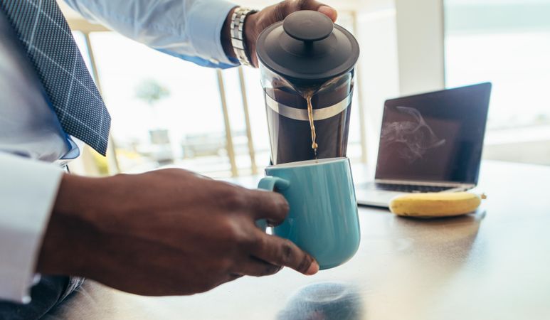 Man pouring coffee from French press