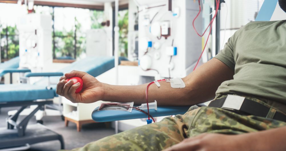 Close Up Of Hand Of Black Army Soldier With Attached Catheter In Military Hospital.