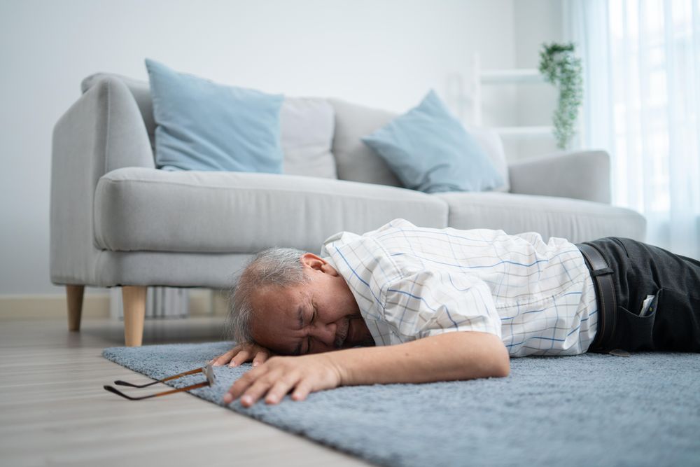 Mature male lying stomach down after collapsing at home