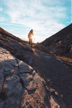 Silhouette of a person hiking in Switzerland at sunrise