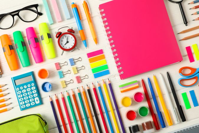 Flat lay composition with school supplies on wooden background