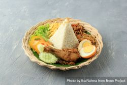 Pyramid of rice in center of nasi uduk breakfast meal bGaZx5