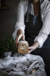 Fresh bread on napkin near tomatoes jam