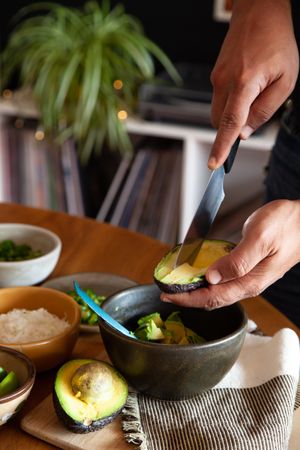Cropped image of person peeling an avocado