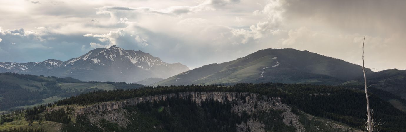 Wide format shot of mountains during a storm in Yellowstone National Park