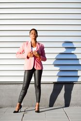 Female in modern business suit standing outside with shadow