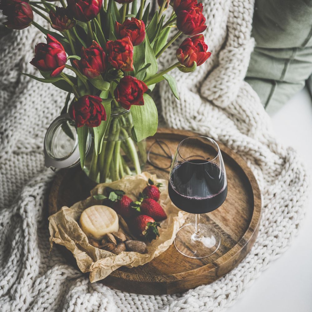 Wine and snacks with flowers square crop