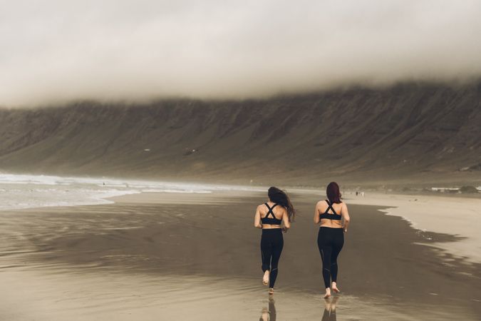 Anonymous women running near sea