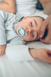 Baby asleep with loving parents