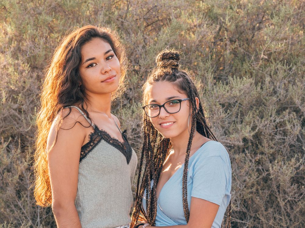 Happy trendy young women bonding at countryside
