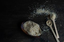 Ground oats with two wooden spoons on counter
