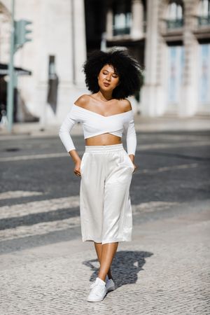 Young stylish female walking outdoors