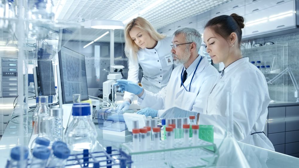Team of Research Scientists Working With Personal Computer, Analysing Test Trial New Generation Drug Data.