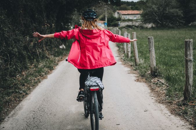 Female riding bicycle without hands