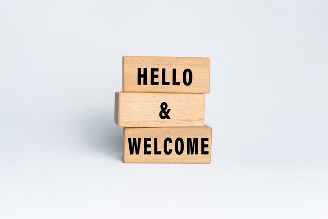 hello and welcome words text on wooden background