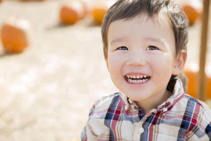 Boy Having Fun at the Pumpkin Patch