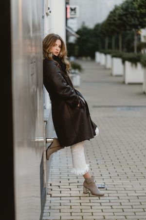 female standing on city street