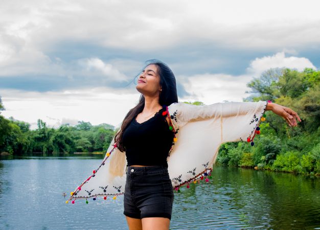 Woman opening her arms joyfully to the sky