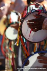 Close-up shot of people playing tambourine at the traditional religious festival of Minas Gerais in Brazil 5kwXj5