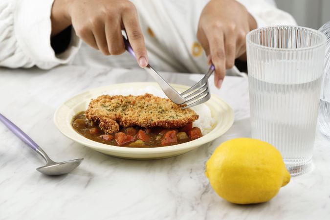 Holding Knife and Fork Eating Tonkatsu Curry