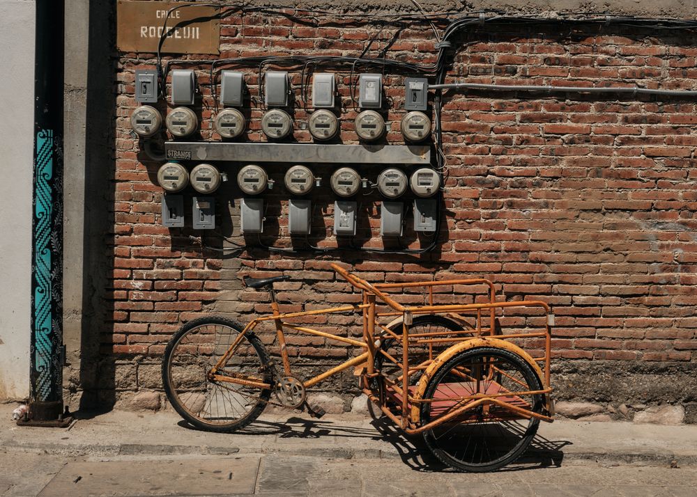 Orange bike with side car on street