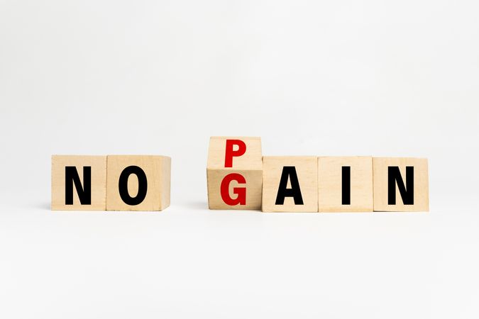 flip wooden blocks with no pain no gain words isolated on plain background