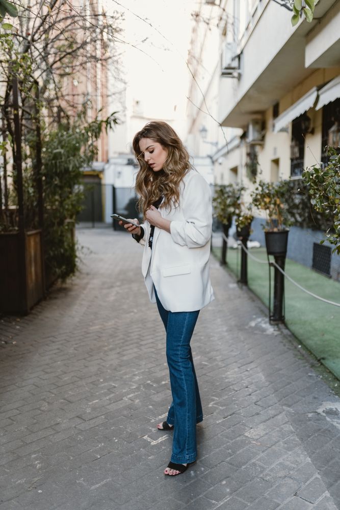 Woman browsing phone on street