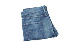 Close-up of folded jeans, isolated on light background