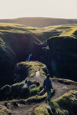 Man walking down trail in nature