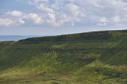 Brecon Beacons mountain range with clouds in the blue sky