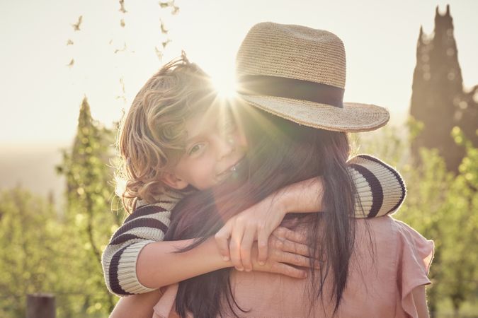 Happy little son with mother in nature