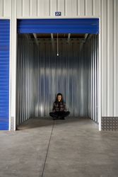 Woman sitting in self storage