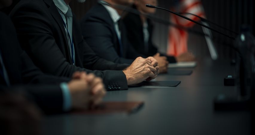 Close Up On Hands of Male Organization Representative Speaking at Economic Conference.