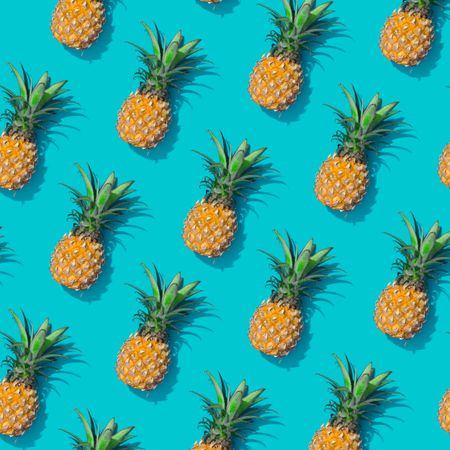 Whole pineapple pattern on a pastel blue background