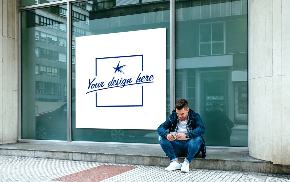 Customizable poster with a guy sitting looking mobile