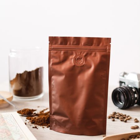 Plain brown packaging decorated with coffee powder and coffee beans
