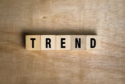 trend words text on wooden blocks on wooden surface