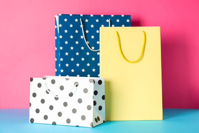 Color paper bags on multicolor background, space for text