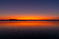 Sunset over shore and lake