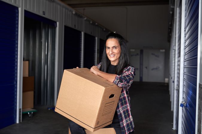 Cheerful woman with packing box