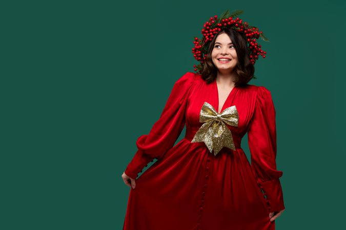 Smiling woman in red dress with gold bow