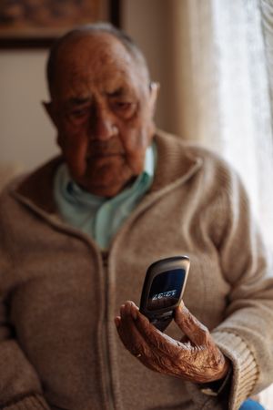 Old person using his phone