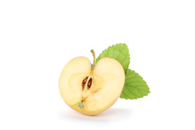 Half apple with leaf isolated on plain background