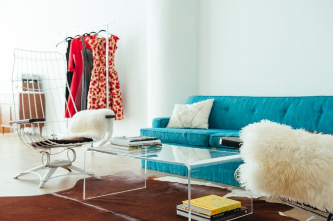 Living room scene with lucite table, vintage couch in bright room