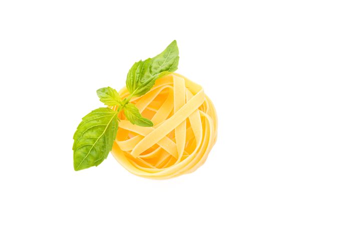 Pasta isolated on light background, top view. Dry uncooked whole pasta